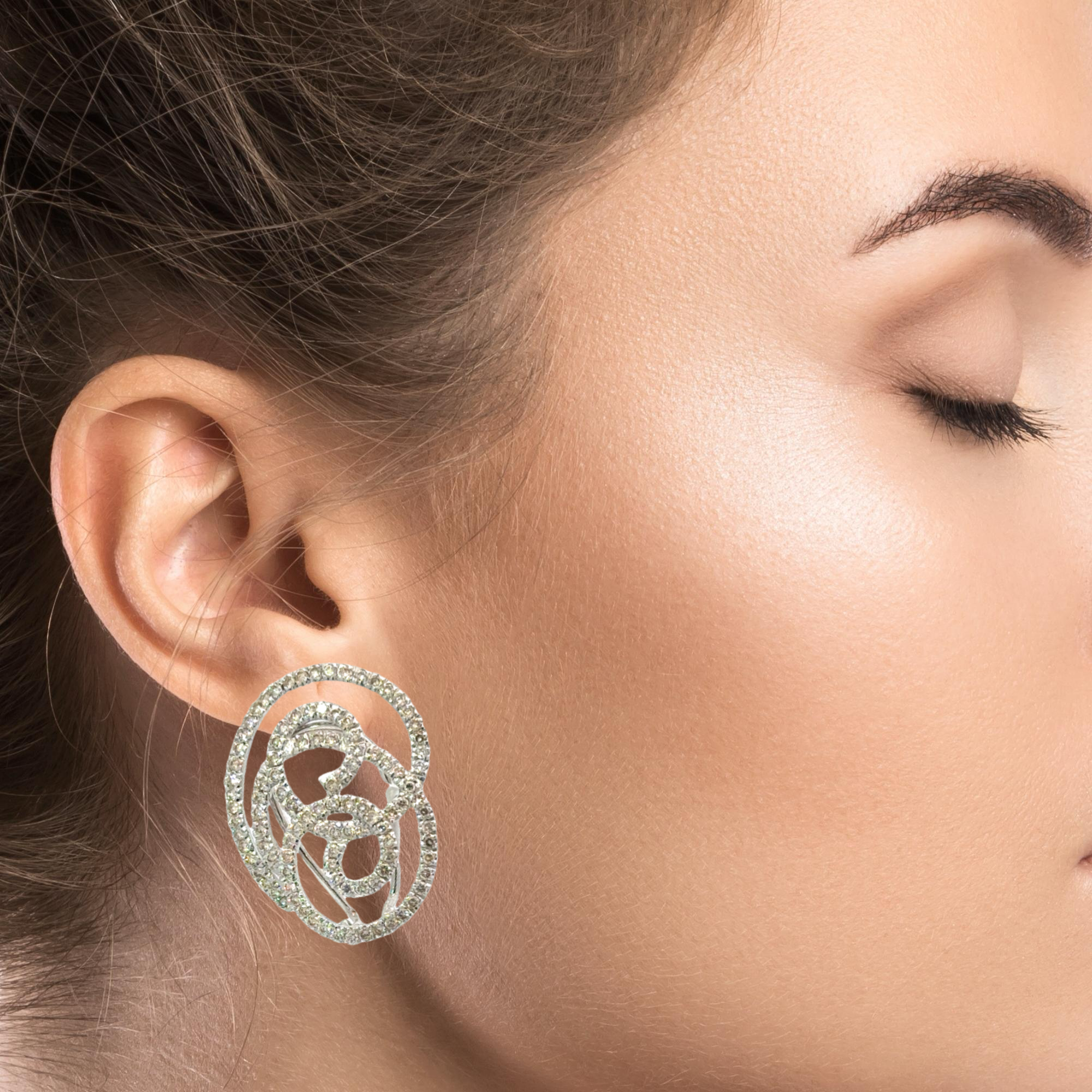 CONTEMPORARY 14 KARAT WHITE GOLD AND DIAMOND EARCLIPS